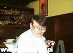Редактор Паровский с недоверием, подчеркнутым двойными очками, всматривается в фантастические часы Эугениуша Дембского. Сам их владелец отсутствует — видимо,  'В поисках потерянного времени'